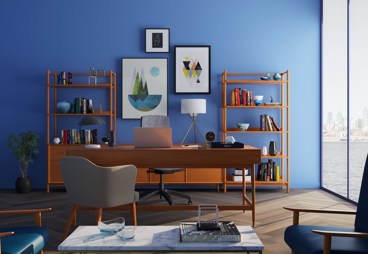 our-journey-02 Elegantly decorated home office with modern furniture and a blue wall.